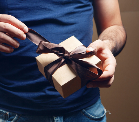 man opening a gift