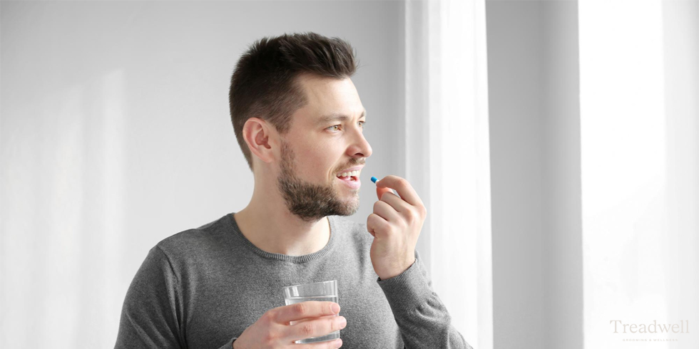 man taking oral supplement